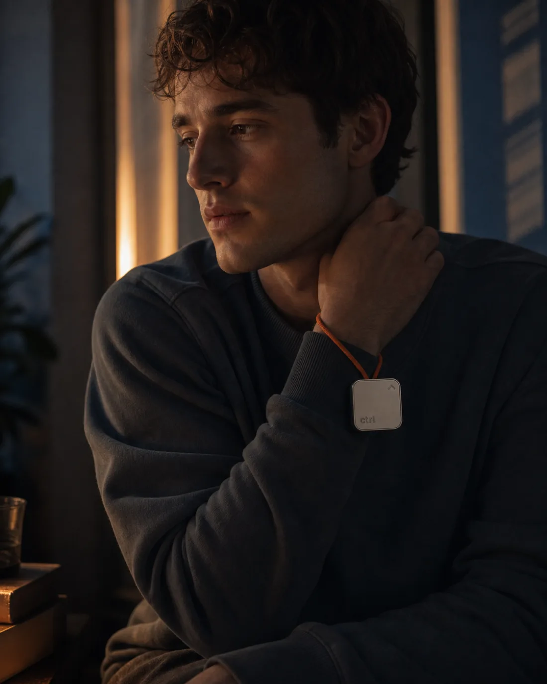 A man standing calmly at a window at dusk holding the ctrl key
