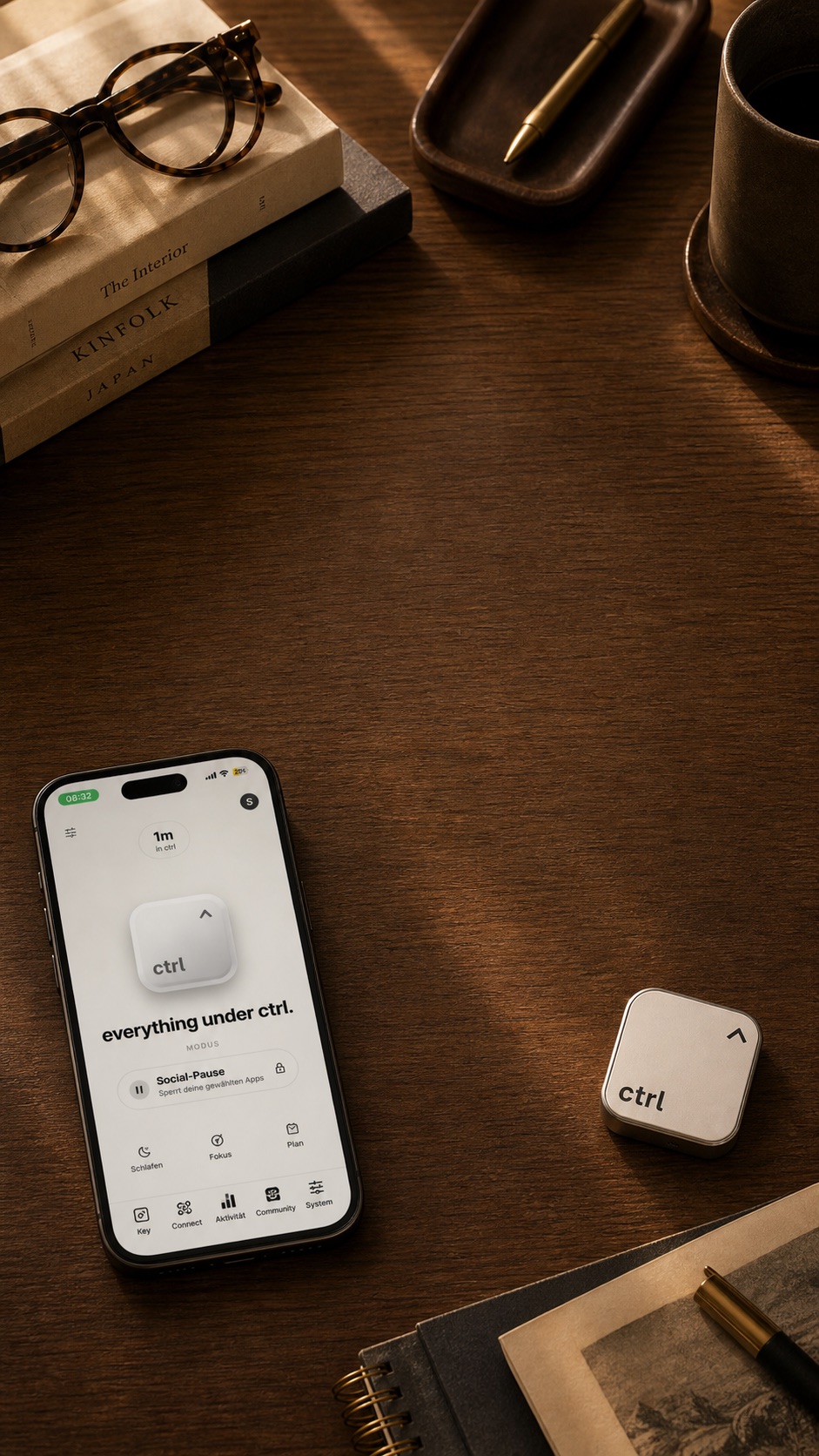 iPhone with the ctrl app home screen next to the ctrl key on a wooden desk