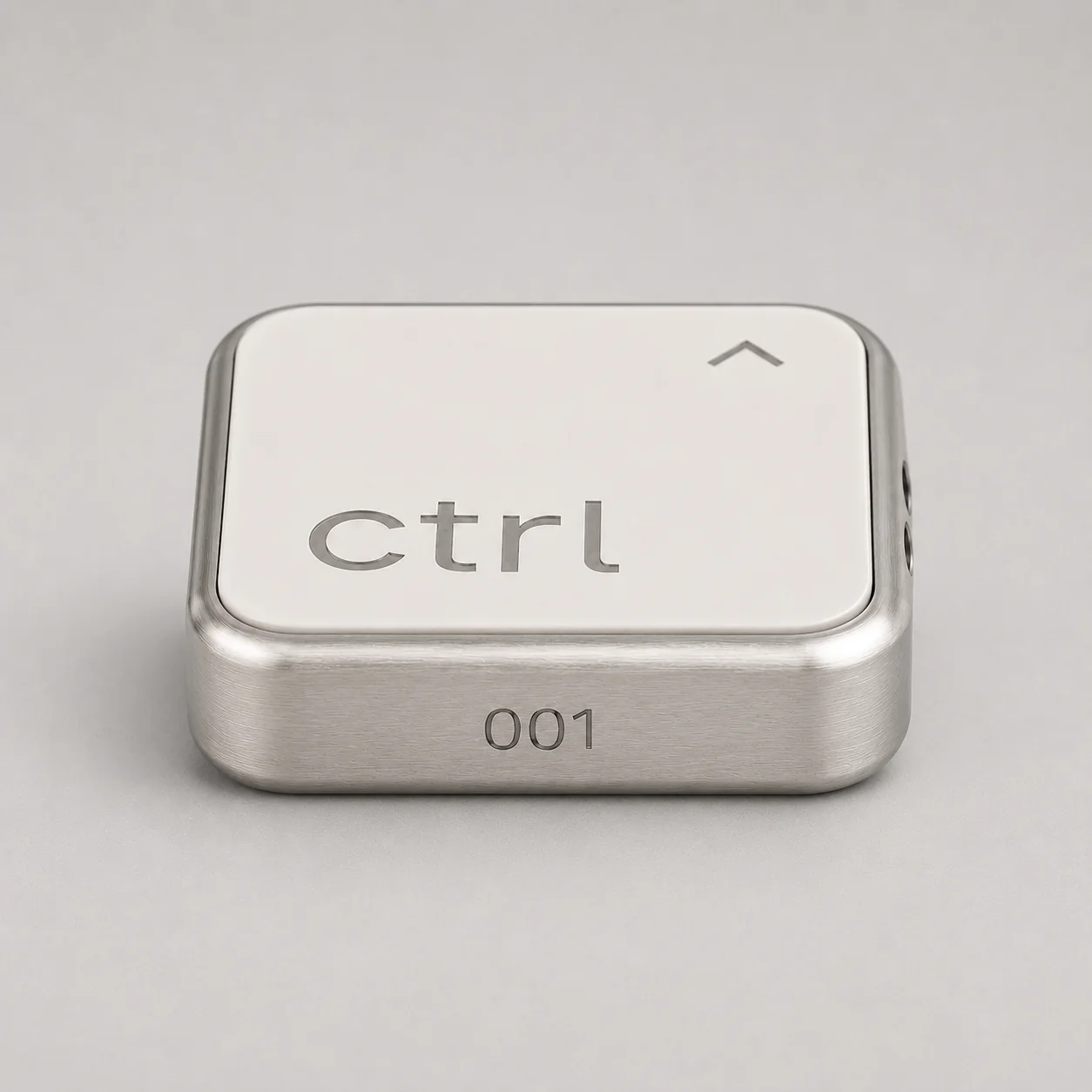 Studio shot of the ctrl key: precision-milled aluminum body, white ceramic face